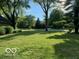 Lush green lawn and mature trees create a serene and inviting atmosphere at 10605 Winterwood, Carmel, IN 46032