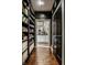 Hallway with dark walls, hardwood floors, and view into the kitchen area at 10605 Winterwood, Carmel, IN 46032