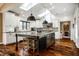 Bright eat-in kitchen featuring a center island with seating, granite counters, and stainless steel appliances at 10605 Winterwood, Carmel, IN 46032