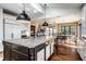 Bright eat-in kitchen featuring a center island with sink, granite counters, and stainless steel appliances at 10605 Winterwood, Carmel, IN 46032