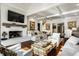 Open living room with fireplace, coffered ceiling, hardwood floors, and neutral decor at 10605 Winterwood, Carmel, IN 46032