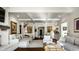 Bright living room featuring hardwood floors, fireplace, and a coffered ceiling at 10605 Winterwood, Carmel, IN 46032
