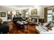 Elegant living room featuring hardwood floors, a fireplace, and designer furnishings at 10605 Winterwood, Carmel, IN 46032