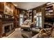 Living room featuring a fireplace, wood paneling, and built-in bookcases at 10605 Winterwood, Carmel, IN 46032