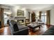 Comfortable living room featuring hardwood floors, a fireplace, and stylish decor at 10605 Winterwood, Carmel, IN 46032