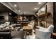 Basement living area offers a cozy brick fireplace, exposed beams and convenient kitchenette at 10605 Winterwood, Carmel, IN 46032