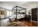 Main bedroom featuring a four-poster bed and ensuite at 10605 Winterwood, Carmel, IN 46032