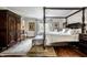 Main bedroom featuring a four-poster bed and large armoire at 10605 Winterwood, Carmel, IN 46032
