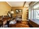 Home office featuring hardwood floors, a vintage desk, and a charming window seat area at 10605 Winterwood, Carmel, IN 46032