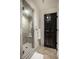 Modern bathroom showcasing a glass-enclosed shower with neutral tiles, a built-in bench, and a towel rack at 10605 Winterwood, Carmel, IN 46032