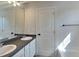 Bathroom with a double sink vanity and a view of the door and tub at 10689 Brooks St, Indianapolis, IN 46234