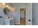 Modern bathroom with sleek vanity, stylish lighting, and a door at 10689 Brooks St, Indianapolis, IN 46234