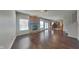 Open-concept living room boasts hardwood floors, a brick fireplace, and ample natural light at 10689 Brooks St, Indianapolis, IN 46234