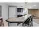 Finished bar with tile countertops, pendant lighting, and bar stool seating at 11347 Whitewater Way, Fishers, IN 46037