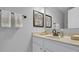 Bathroom featuring a marble sink, bronze faucet, decorative artwork, and a large mirror at 11347 Whitewater Way, Fishers, IN 46037