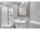 Bathroom featuring a glass-enclosed shower, toilet, and pedestal sink, with a decorative mirror at 11347 Whitewater Way, Fishers, IN 46037