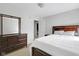 Comfortable bedroom with a bed and dark wood dresser and matching bed frame at 11347 Whitewater Way, Fishers, IN 46037