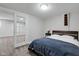 Cozy bedroom features gray wood floors, a comfortable bed, and a glass panel door for easy access at 11347 Whitewater Way, Fishers, IN 46037