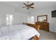 A Primary bedroom featuring a ceiling fan, dresser, and large bed with leather trim at 11347 Whitewater Way, Fishers, IN 46037