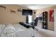 A bedroom with bed, desk, black gaming chair, shelves, and wall art at 11347 Whitewater Way, Fishers, IN 46037