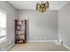 Spacious bedroom featuring neutral paint, carpeted floors, and decorative beaded chandelier light fixture at 11347 Whitewater Way, Fishers, IN 46037
