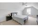This bedroom has neutral colors, a ceiling fan, and a dormer at 11347 Whitewater Way, Fishers, IN 46037