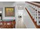 Inviting foyer featuring a staircase, tiled flooring, and stylish decor, offering a glimpse of the home's elegance at 11347 Whitewater Way, Fishers, IN 46037