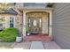 Elegant entryway with a decorative front door, brick accents, and a welcoming porch, highlighting architectural details at 11347 Whitewater Way, Fishers, IN 46037