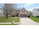Beautiful brick house with attached garage, driveway, and manicured lawn at 11347 Whitewater Way, Fishers, IN 46037
