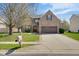 Beautiful two-story brick home featuring an attached garage and manicured front yard, offering timeless appeal at 11347 Whitewater Way, Fishers, IN 46037