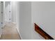Well-lit hallway with carpet flooring, connecting different areas of the home, with railing accent at 11347 Whitewater Way, Fishers, IN 46037