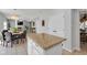Open concept kitchen island with granite countertop overlooks adjacent dining and living areas at 11347 Whitewater Way, Fishers, IN 46037