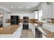 Bright kitchen with white cabinets, granite counters, and stainless steel appliances offers ample counter space and storage at 11347 Whitewater Way, Fishers, IN 46037