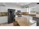 Beautiful kitchen featuring white cabinetry, stainless appliances, and a large island with granite countertops at 11347 Whitewater Way, Fishers, IN 46037