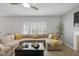 Living room with a large sectional sofa, fireplace, and decorative sliding barn doors at 11347 Whitewater Way, Fishers, IN 46037