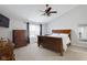 Main bedroom featuring a ceiling fan and a large window, along with a cozy bed at 11347 Whitewater Way, Fishers, IN 46037