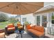 Relaxing patio area with comfortable seating and umbrella for shade at 11347 Whitewater Way, Fishers, IN 46037
