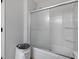 Shower stall with sliding glass door and white tiled walls at 11347 Whitewater Way, Fishers, IN 46037