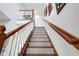 Carpeted staircase with a wooden railing, leading up to the next floor of the house at 11347 Whitewater Way, Fishers, IN 46037