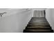Staircase featuring dark wood steps and modern white walls at 11347 Whitewater Way, Fishers, IN 46037
