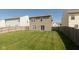 The backyard of the house featuring a green lawn and a wooden fence at 11617 Tahoe Way, Indianapolis, IN 46235