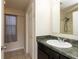 This bathroom features a vanity with granite countertop, a mirror, a sink, and a shower tub combo at 11617 Tahoe Way, Indianapolis, IN 46235