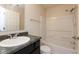 This bathroom features a vanity with granite countertop, a mirror, a sink, a toilet, and a shower tub combo at 11617 Tahoe Way, Indianapolis, IN 46235