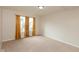 This bedroom features neutral walls, carpet flooring, and two windows with golden curtains at 11617 Tahoe Way, Indianapolis, IN 46235