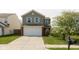 Charming two-story home with a well-maintained lawn and attached two-car garage at 11617 Tahoe Way, Indianapolis, IN 46235