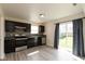 Updated kitchen featuring modern appliances, dark cabinets, and a sliding glass door to the backyard at 11617 Tahoe Way, Indianapolis, IN 46235