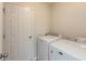 Bright laundry room featuring modern washer and dryer units and ample storage at 11617 Tahoe Way, Indianapolis, IN 46235