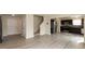 Open-concept living space featuring gray vinyl floors, stairs, and a modern kitchen at 11617 Tahoe Way, Indianapolis, IN 46235