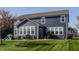 Exterior back of a blue house featuring a patio and well-maintained lawn at 11880 Whisper Ridge Dr, Noblesville, IN 46060