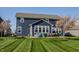 Back exterior view of a two-story home with manicured lawn and a patio area at 11880 Whisper Ridge Dr, Noblesville, IN 46060